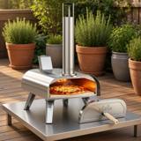 Big Horn 12-inch stainless pizza oven on a steel table on a deck, a pizza on the stone and its door beside it