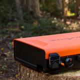 Blackstone 2363 closed for travel on a stump, orange hood latched over the case, corner latch and left knob in view