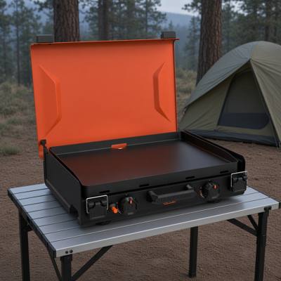 Blackstone 2363 camping griddle open, orange hood raised over an empty black coated plate, two knobs on the front