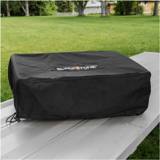 Covered Blackstone 22 inch tabletop griddle on a metal picnic table, drawcord and cord lock hanging at the front corner