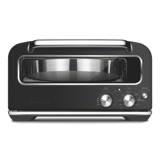 Breville Smart Oven Pizzaiolo in brushed stainless, a pizza on the stone visible through the front window