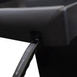 A Broil King grill tool hanging from the hook under the Crown 410 Shadow folded side shelf