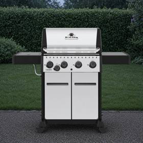 Broil King Crown S 440 with a stainless lid and cabinet doors, black shelves out, four knobs and a side burner knob