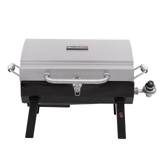 Char-Broil 465640214 portable gas grill, stainless lid latched shut, standing on its folding legs behind a van