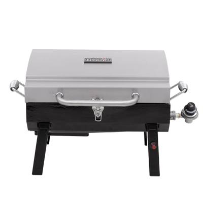 Char-Broil 465640214 portable gas grill, stainless lid latched shut, standing on its folding legs behind a van
