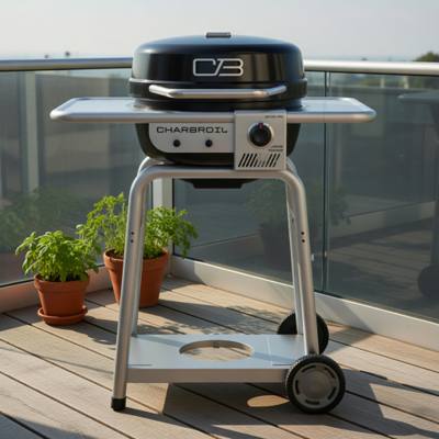 Char-Broil Bistro Pro on a wooden balcony deck, black lid closed, silver shelves and cart, glass railing behind