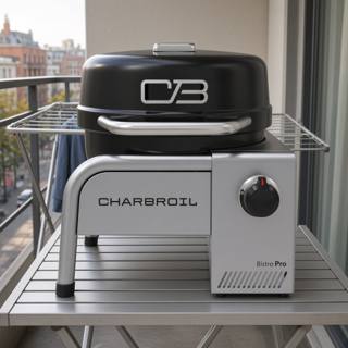 Char-Broil Bistro Pro tabletop gas grill on a balcony table, black lid closed, silver body with one control knob