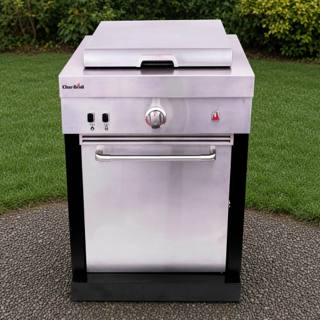 Char-Broil Medallion griddle module on gravel beside a lawn, stainless cabinet, lid closed, black corner posts