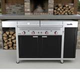 Char-Broil Vista outdoor kitchen head-on, two closed stainless lids, four red-collared knobs, black doors, on casters