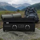 Char-Broil 22-inch tabletop gas griddle on a rock outdoors, black body, two control knobs, mountains behind