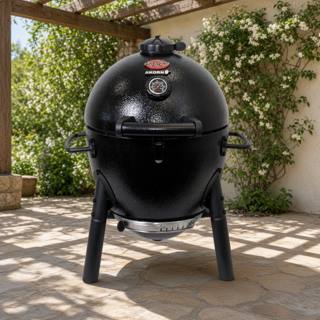 Black Char-Griller AKORN Jr. kamado on three legs on a sunny stone patio
