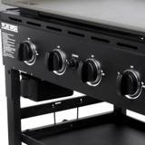 Close view of the Flat Iron control panel: four knobs, igniter button, and the slide-out grease drawer beneath