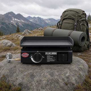 Black Char-Griller Flat Iron portable griddle on a rock at a misty mountain camp, single knob, hose fitted