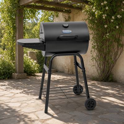 King-Griller Gambler E1416 barrel charcoal grill on its four-leg cart, lid shut, side shelf out, on a stone terrace