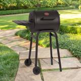 Char-Griller Patio Pro barrel charcoal grill on a stone garden path, lid shut, side damper on the right end