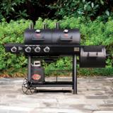 Texas Trio 3070 on a flagstone patio against shrubs, lids closed, propane tank bagged below the cart
