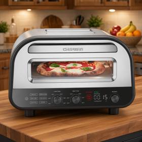 Chefman indoor pizza oven on a wooden kitchen counter, a pizza baking behind the window