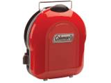 Coleman 2000020932 closed on white, three-quarter view, wire carry handle raised and red igniter button at the side