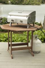 Cuisinart CGG-306P grill on a wooden garden table, hose running down to a 20 lb propane tank standing on the deck