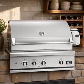 DCS 36-inch Series 9 built-in stainless gas grill, hood closed, rotisserie motor housing on the right