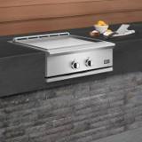 DCS 30-inch Series 9 griddle built into a dark stone outdoor island, lid open, vent along the rear edge