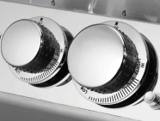 Close-up of two chrome Fire Magic control knobs, panel legend reading OFF, LIGHT, HI and LOW with a flame icon
