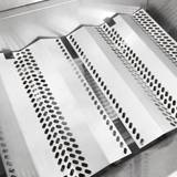 Close-up of the perforated stainless Flavor Grids seated over the burners inside the C430i firebox