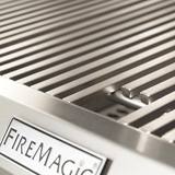 Close-up of the CM430i Diamond Sear stainless cooking grids above the Fire Magic nameplate on the panel