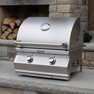 Fire Magic CM430i stainless grill head on a stone counter, hood closed with an analog thermometer and two control knobs