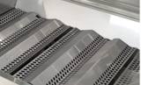 Close-up of the CM430s perforated stainless Flavor Grids sitting in peaks above the burners