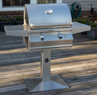 Fire Magic CM430s stainless grill on a post with a square base plate, bolted to a gray timber deck, timer dial on the post