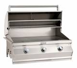 Fire Magic CM650i with the hood open, showing the full-width cooking grid and the warming rack above it