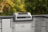 Fire Magic EL500i dropped into a gray outdoor kitchen island, refrigerator at left and drawer stack at right