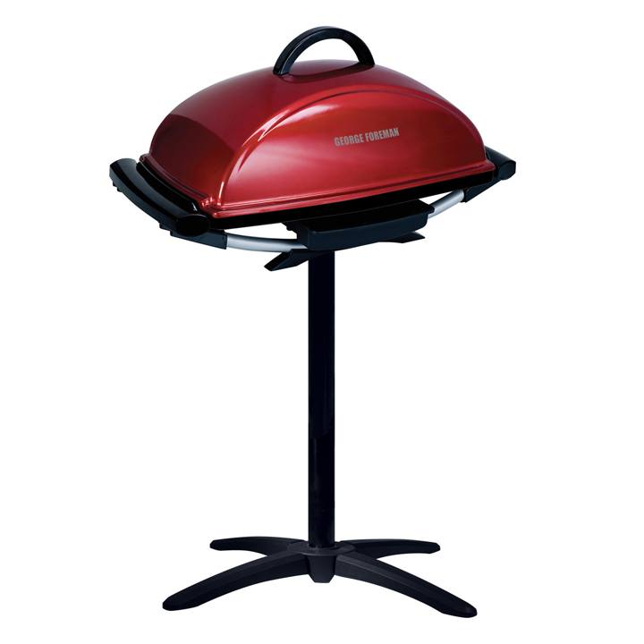 Red George Foreman GFO201R with its domed lid shut, sitting on a black pedestal stand with a four-footed base