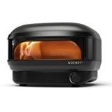 Gozney Arc Lite propane pizza oven in Off Black, flame lit along the left wall, control dial on the base