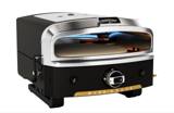 Halo Versa 16 gas pizza oven with its top burner lit blue above the round stone, black body and stainless front arch