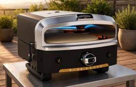 Halo Versa 16 on a steel outdoor table on a deck in evening light, top burner lit above the stone