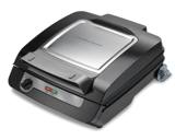 Front three-quarter view of the closed MultiGrill Plus showing the lid latch, temperature dial and side handles