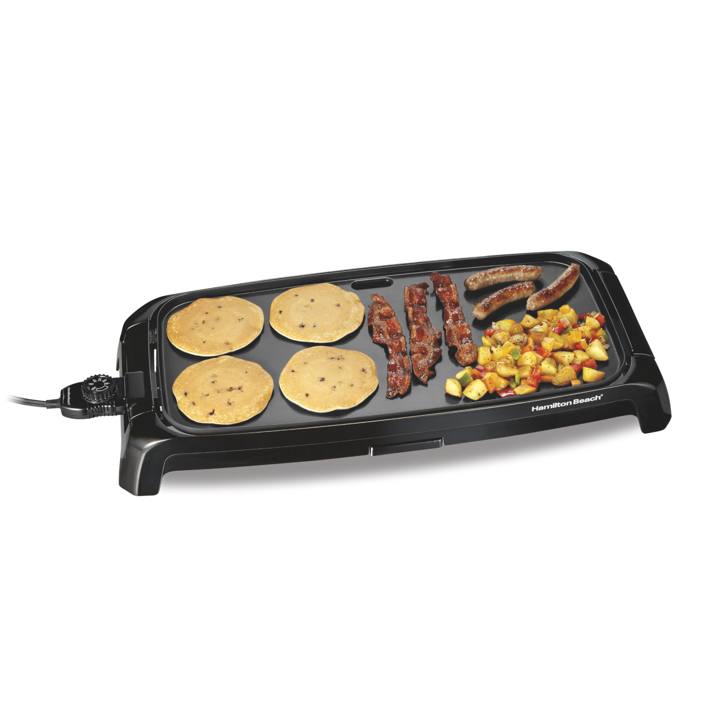 Hamilton Beach 38522 griddle cooking blueberry pancakes, bacon, sausages and diced potatoes, cord entering at the left