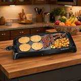 Hamilton Beach 38522 griddle cooking blueberry pancakes, bacon, sausages and diced potatoes, cord entering at the left