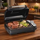Hamilton Beach 25375 indoor searing grill, cover raised, steaks and asparagus on the plate, smoke chamber at right