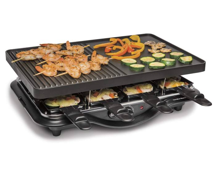 Hamilton Beach 31612MN-MX raclette grill, ribbed and flat plate raised above eight loaded personal trays