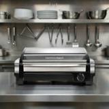 Hamilton Beach 25360 searing grill on a plain background, stainless hood raised above the ribbed nonstick plate