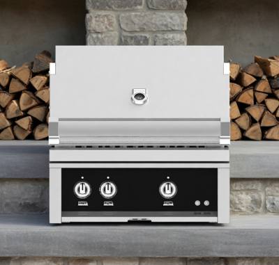 Hestan 30-inch built-in gas grill in a stone counter, stainless hood closed, black panel with three knobs.