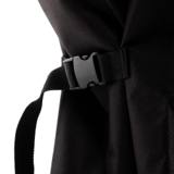 Black webbing strap pulled through a plastic side-release buckle on the flank of the Kamado Joe cover