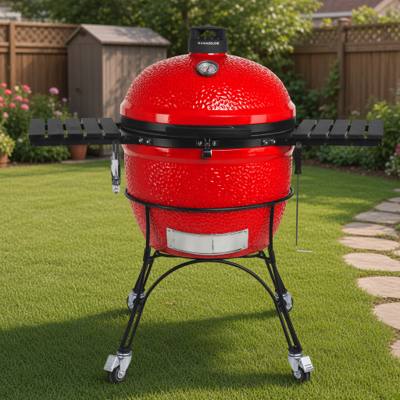 Kamado Joe Big Joe II in red on its black cast iron cart, both slatted side shelves folded out
