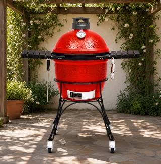 Red ceramic Kamado Joe Classic II on a black rolling stand under a wooden pergola, side shelves out, lid closed