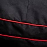 Close-up of the black woven polyester cover with two lines of red piping stitched across it