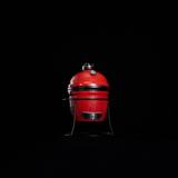 Joe Jr on its cast iron stand photographed small and centred against a black background, lower vent door facing front