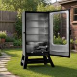 Masterbuilt 40 inch electric smoker on its legs on a lawn, window door open to four empty racks